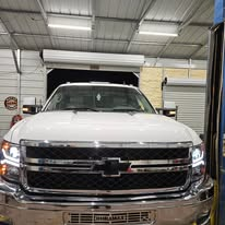 Mechanic working on a chrome suspension assembly